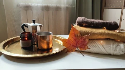 Autumn theme 4k footage. Stack of knitted sweaters, a maple leaf and a Stock Footage 220070061