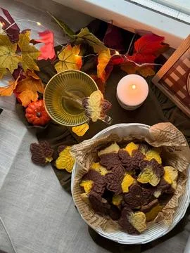 Autumn-themed-flat-lay-with-leaf-cookies-tea-and-candle Stock Photos