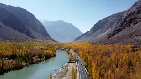 Autumn transforms Kargil’s riverside into a glowing natural masterpiece. Stock Footage 310782290
