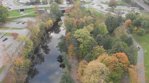 Autumn Trees Along Both Sides of River, Slow Pull Back Aerial Stock-Footage 143067835