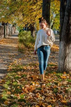 Autumn walk on leaf-covered path with fall colors Stock Photos