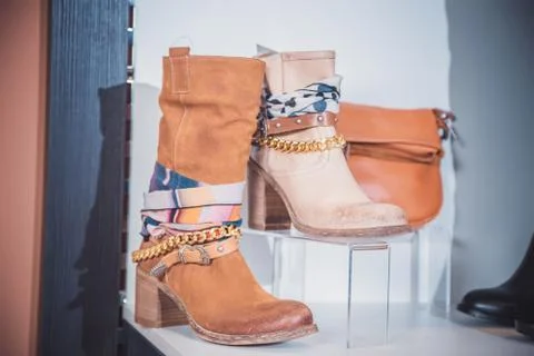 Autumn women's boots lying on the shelf Stock Photos