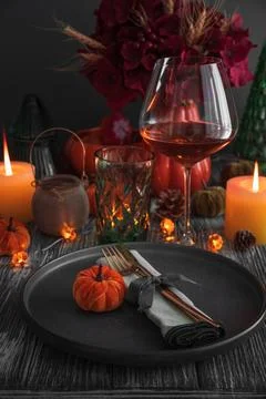 Autumnal dinner table setting featuring festive pumpkins and candles Stock Photos