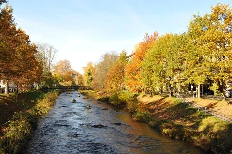 Autumnal river with structures, Long perspective river view featuring fall .. Stock Photos