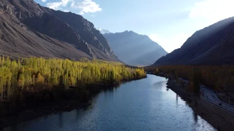 Autumn’s warm glow mirrors on a tranquil river bend. Stock Footage 310782906