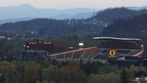 Autzen Stadium with Mighty O Oregon scoreboard and Ducks logo on seating Stock Footage 336504045