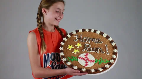 Ava smiles by seeing the delicious cookie in her hand Stock Footage 22734489