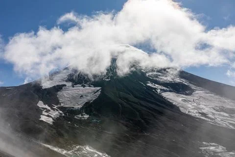Avachinsky Volcano summit with clouds and snow, Kamchatka Peninsula landscape Stock Photos