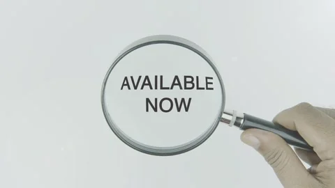 Available Now text or word highlighted by a magnifying glass in a hand Stock Footage 303584789