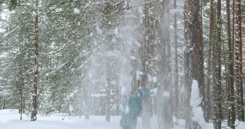 An avalanche fell from a tree onto a man in a turquoise jacket. Stock Footage 265216635