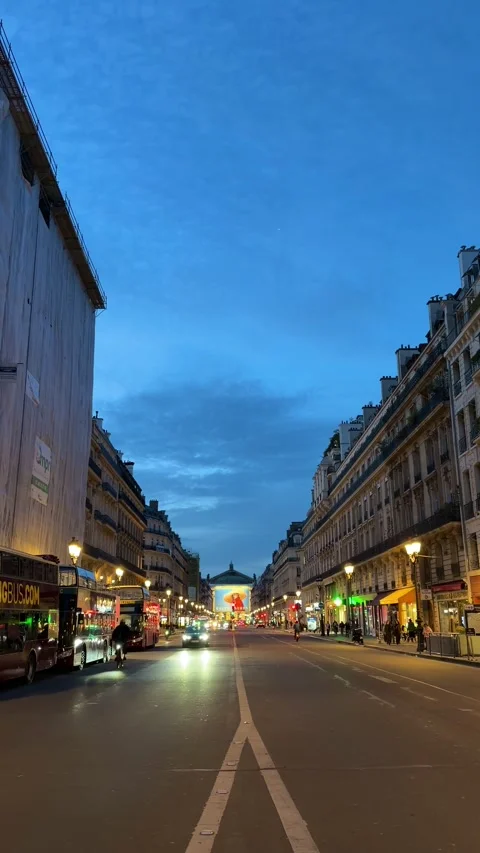 Avenue de l'Opéra in Paris at twilight with city traffic Stock Footage 337782893