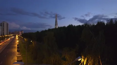 Avenue park view of the skyscraper in the evening purple sunset lakhta center Видео 160357872