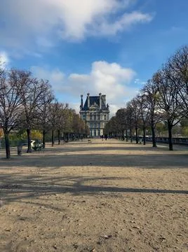 Avenue of trees in autumn leading to the Musee du Louvre in Paris France Stock Photos