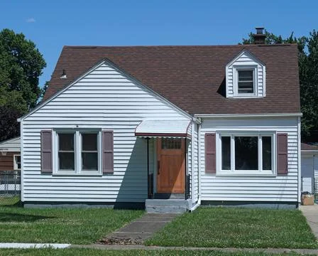 Average American house, white clapboard with gable and front lawn Stock Photos