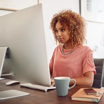 Average is not an option. a young designer working on her computer. Stock Photos