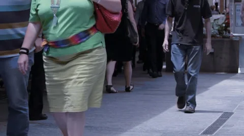 Average pedestrians walking on the foot path Stock Footage 33802096