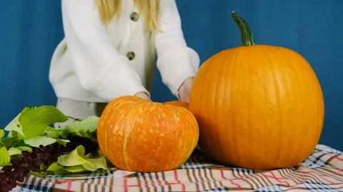 The average plan of the girl and the composition of the pumpkins. Stock Footage 210179237