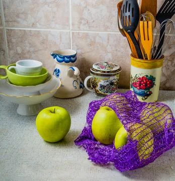 Average plan. Green apples on the kitchen table. Stock Photos