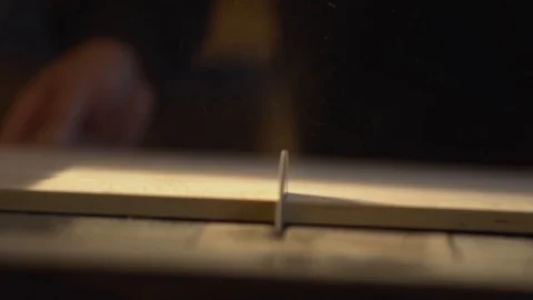 The average plan. Sawdust flies when sawing the board with a circular saw Stock Footage 107611499