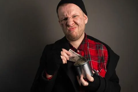 The average plan of a surprised beggar who takes out banknote and is upset by Stock Photos