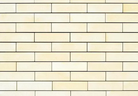 The average texture of the walls are light yellow bricks. Background. Stock Photos