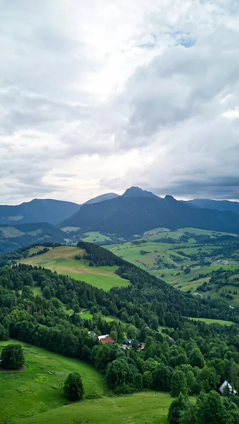 AVertical aerial HyperlapseOver Rolling Green Hills Forests Sheep Enclosure Stock-Footage 317762161