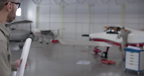 Aviation engineer studying airplane drawings Stock Footage 104664232
