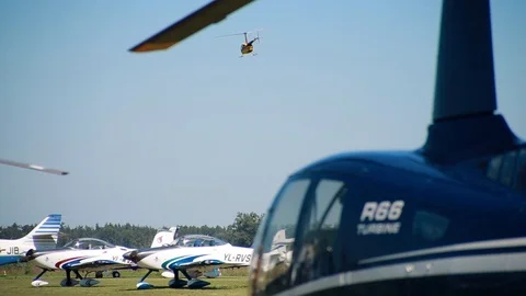 Aviation feast holiday. Small light helicopter flies over the airfield  Stock Footage 101059219