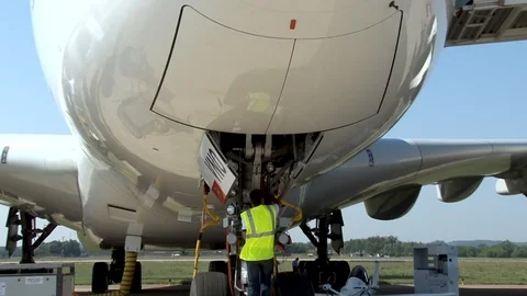 Aviation mechanic performs maintenance on Airbus A-380 on static parking lot. Stock Footage 106967702