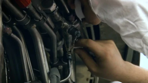 Aviation structure in Russia. Worker puts valves on special tubes Stock Footage 105824080