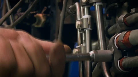 Aviation structure. The worker screws the screws into the pipes with a tool Stock Footage 105824333