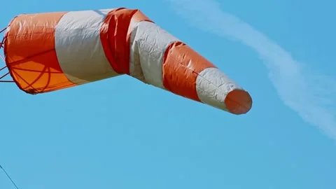 An aviation wind deflection cap flutters against a blue sky Stock Footage 281939796