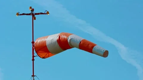 An aviation wind deflection cap flutters against a blue sky Stock Footage 281939954