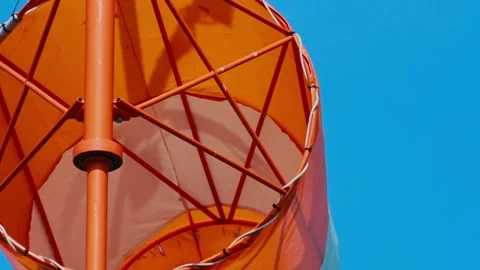 An aviation wind deflection cap flutters against a blue sky Stock Footage 281940035