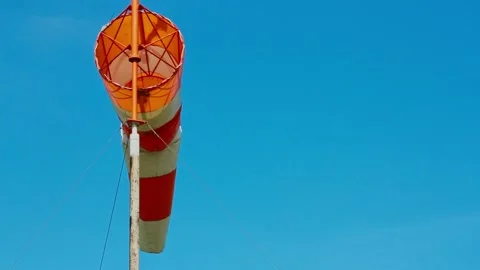 An aviation wind deflection cap flutters against a blue sky Stock Footage 281940151