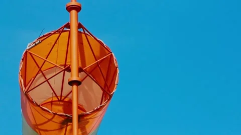 An aviation wind deflection cap flutters against a blue sky Stock Footage 281940211