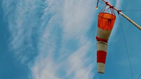 An aviation wind deflection cap flutters against a blue sky Stock Footage 281940386