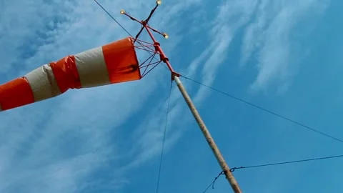 An aviation wind deflection cap flutters against a blue sky Stock Footage 281940394
