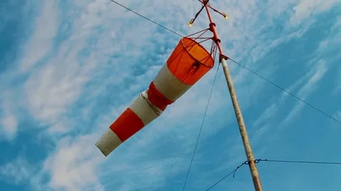 An aviation wind deflection cap flutters against a blue sky Stock Footage 281940753