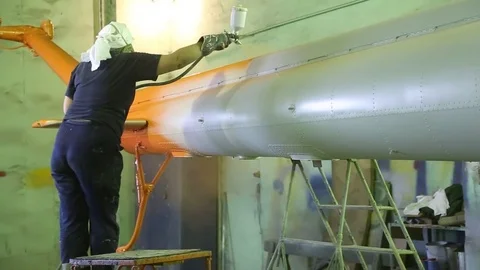 Aviation workshop. The worker paints the tail of the helicopter. Stock Footage 81220105