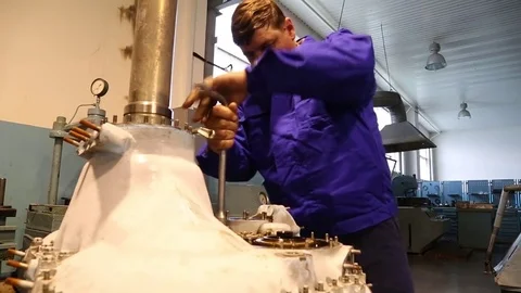 Aviation workshop. The worker screws the part with the key. Stock Footage 81223712