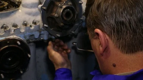 Aviation workshop. The worker screws the part with the key. Stock Footage 81223715