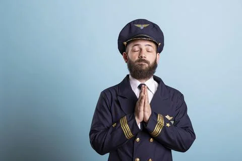 Aviator praying for good luck before piloting commercial flight Stock Photos