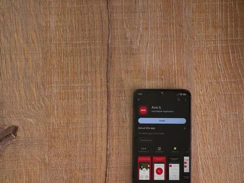 Avis IL app play store page on smartphone on wooden background Stock Photos