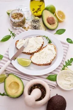 Avocado and cream cheese toasts preparation - grilled or toasted bread with Stock Photos