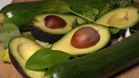 Avocado and cucumbers spinning on a table Stock Footage 249988881