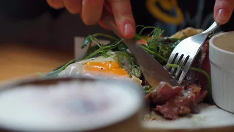 Avocado and poached egg on top, knife cut it and yolk run out. Stock Footage 242805723