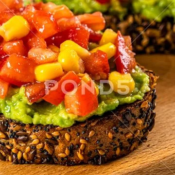 Avocado And Sweetcorn Salad On Toast With Tomatoes Stock Photos