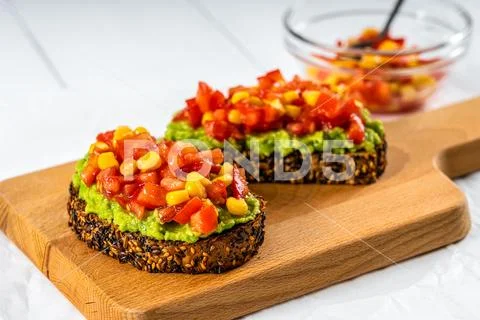 Avocado And Sweetcorn Salad On Toast With Tomatoes Stock Photos