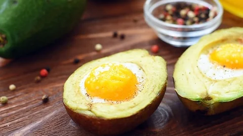Avocado baked with egg, pepper and salt Video stock 71347494